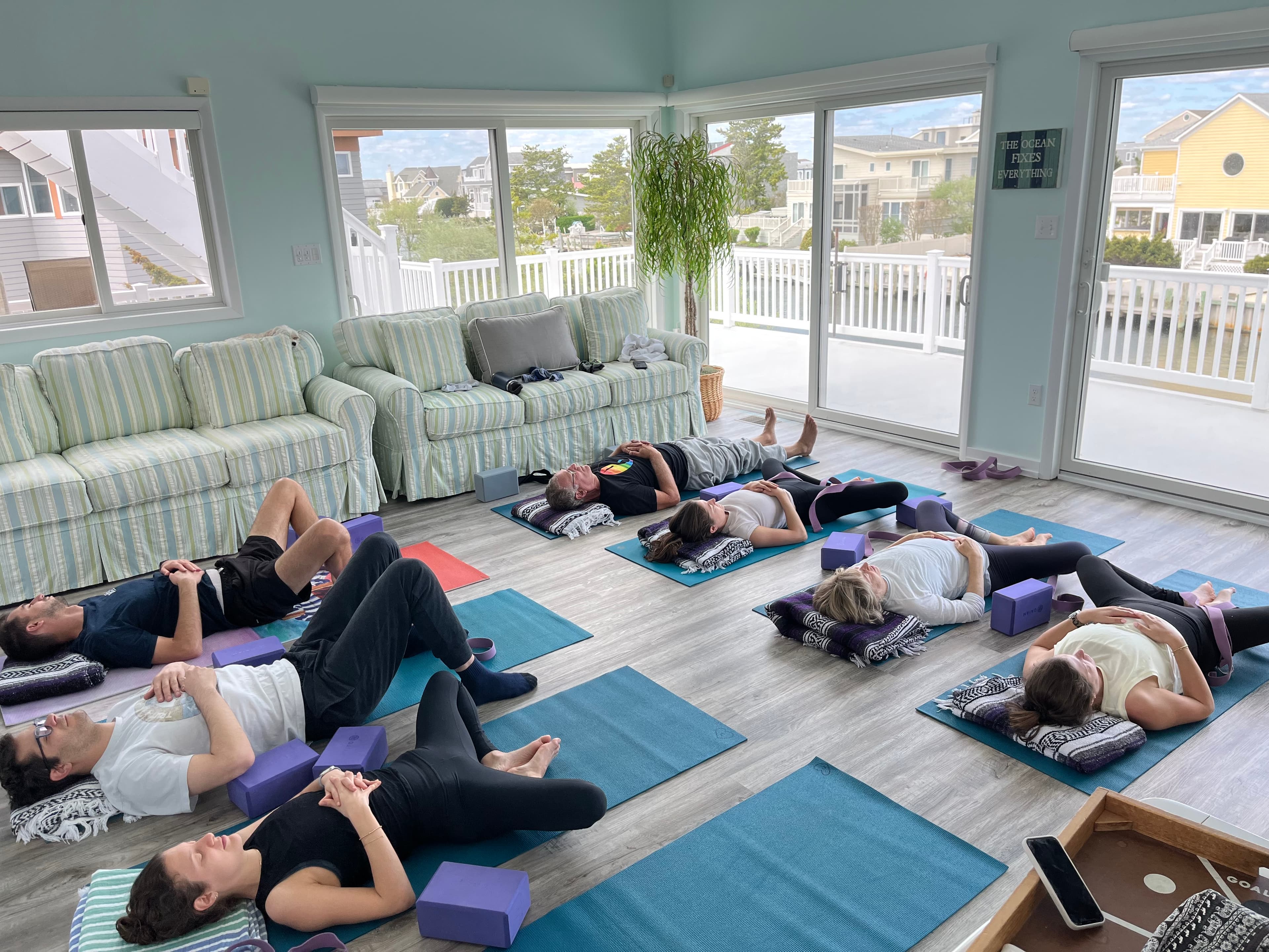 Private restorative yoga session in a beachside home